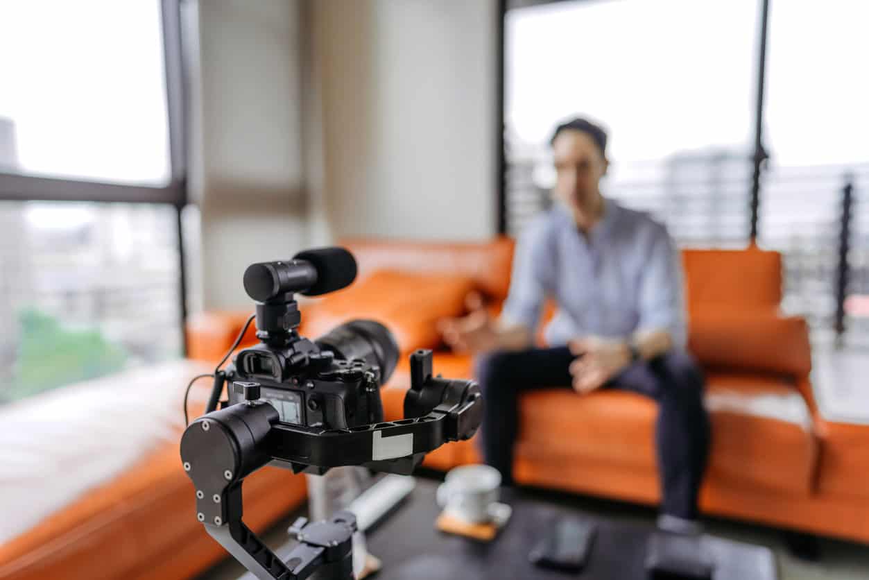 Instructor explains a concept to a group of participants sitting by a table