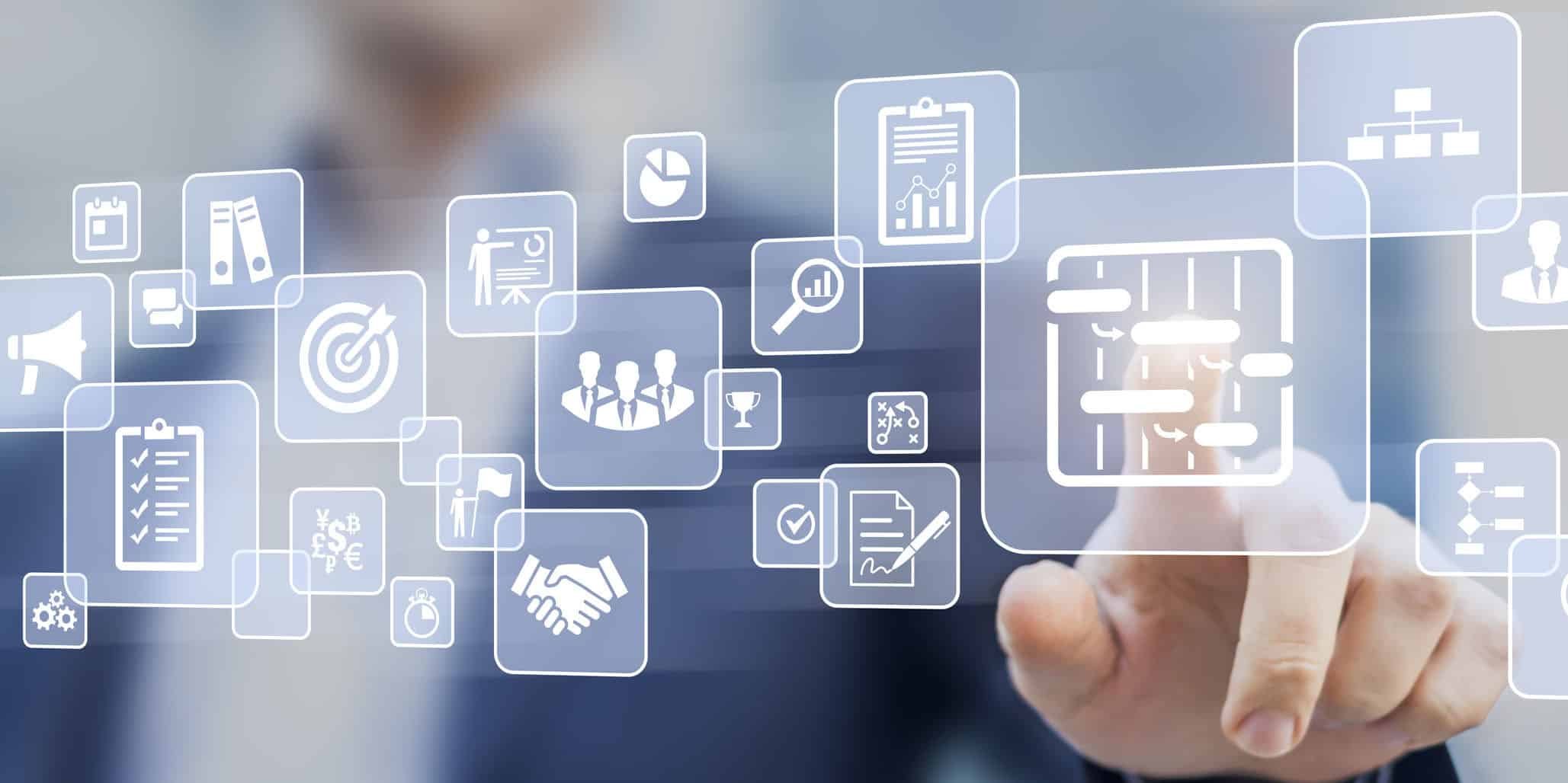 Instructor explains a concept to a group of participants sitting by a table